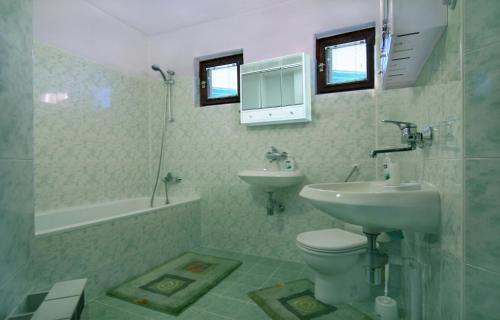 a bathroom with a sink and a toilet and a tub at Eco Apartments Plovdiv in Plovdiv