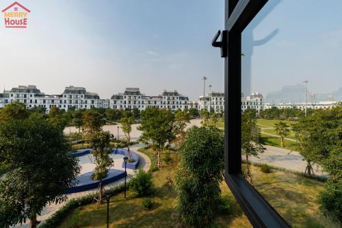 a view of a park from a window in a hotel at Merry House Imperia in Hai Phong