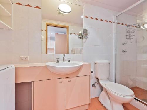 a white bathroom with a sink and a toilet at Lhotsky Studio 1 Bedroom with quiet location and onsite parking in Thredbo