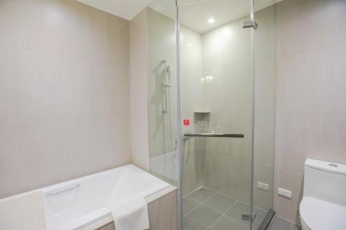 a bathroom with a shower and a toilet at Jin Shi Hu Hotel in Kaohsiung