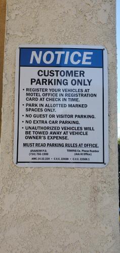 a sign is posted on the side of a building at Anaheim National Inn in Anaheim