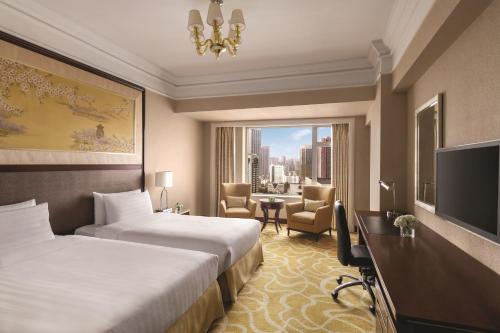 a hotel room with two beds and a television at Shangri-La Wuhan,Close to The Mixc with three subway lines in Wuhan