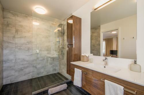 a bathroom with a sink and a shower at Queenstown Country Lodge in Queenstown