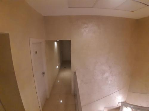 an empty room with a corridor and a hallway at Albergo Viola in Naples