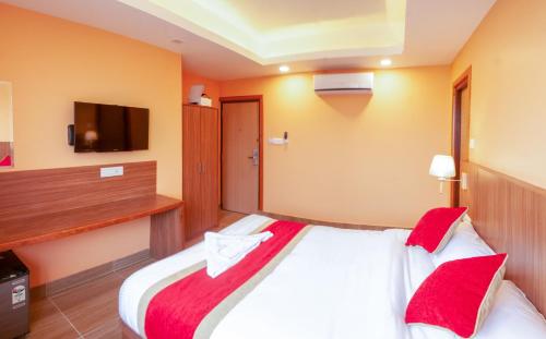 a hotel room with a large bed with red pillows at Hotel Krishna Kathmandu in Kathmandu