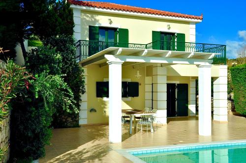 a house with a patio and a swimming pool at Seaside Villa Kefaloniaprivatevillas in Argostoli