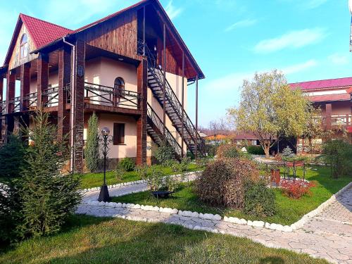 a large building with a staircase on the side of it at Котедж-парк Славна in Okhtyrka