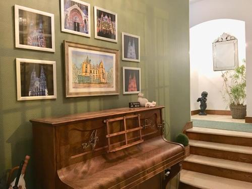 a room with a piano and pictures on the wall at Maunoury Citybreak in Chartres