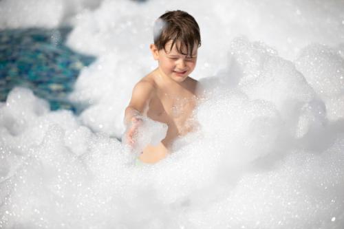 a young boy is in a bubble bath at Grande Centre Point Pattaya in Pattaya Central