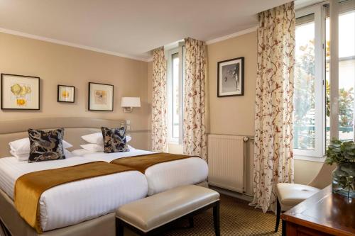 En eller flere senge i et værelse på Hotel Relais Bosquet by Malone
