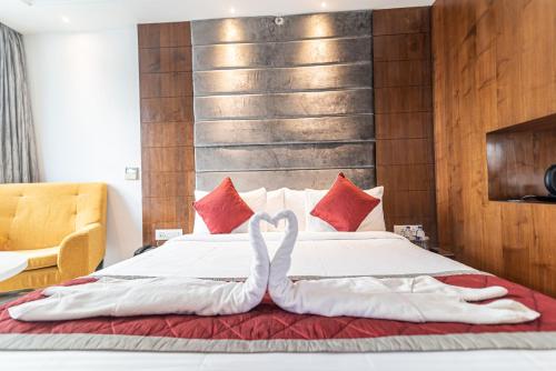 a bed with two swans made out of towels at Bhagini Icon Premier Hotel in Bengaluru