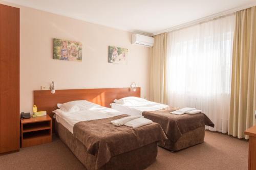 Ένα ή περισσότερα κρεβάτια σε δωμάτιο στο SmolinoPark Hotel