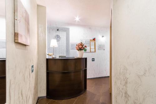 a room with a counter with a vase of flowers on it at Mini Hotel Pomestie in Saint Petersburg