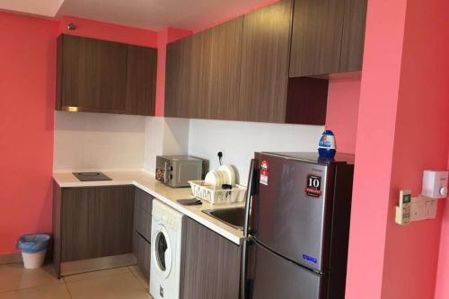 a kitchen with a refrigerator and a washing machine at B17-15-Amazing Lake view studio unit, Hyve,Cyberjaya, Free WiFi, Free Parking, Netflix, Pool, 3044 in Cyberjaya