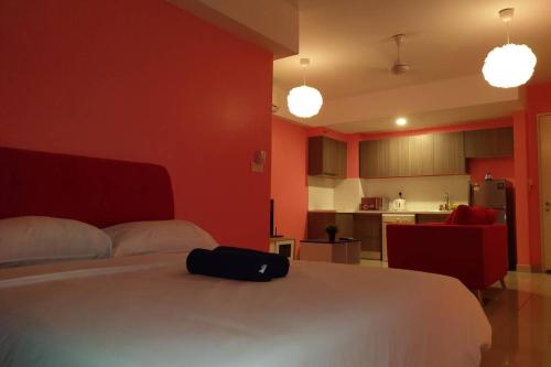 a bedroom with a white bed with a black bag on it at B17-15-Amazing Lake view studio unit, Hyve,Cyberjaya, Free WiFi, Free Parking, Netflix, Pool, 3044 in Cyberjaya