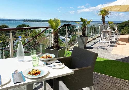 a white table with plates of food on a balcony at Harbour Heights Hotel in Poole