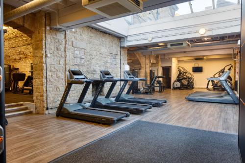 a gym with rows of tread machines in a room at Mercure Blackburn Dunkenhalgh Hotel & Spa in Blackburn