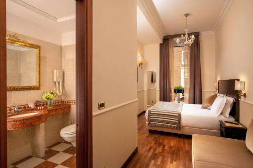 a hotel room with a bed and a bathroom at Hotel Del Corso in Rome