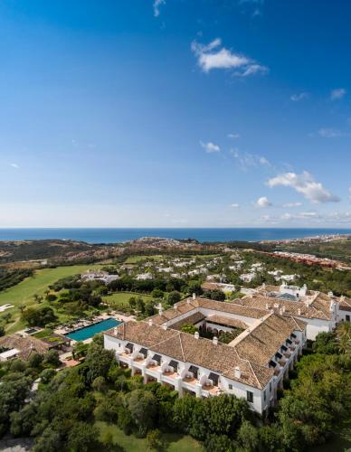 an aerial view of a house with the ocean in the background at Finca Cortesin Hotel Golf & Spa in Casares