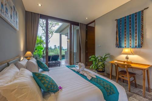 a bedroom with a large bed with towels on it at Lavanya Ubud Romantic Villas in Ubud