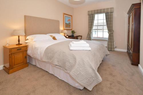 a bedroom with a large bed with towels on it at The Sutherland Arms in Stoke on Trent