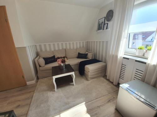 a living room with a couch and a table at Pension Reinhardshäusle in Reinhardshausen