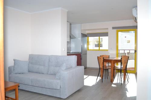 a living room with a couch and a table at Rocha Apartment 1016 in Portimão