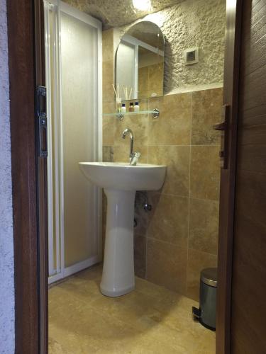 a bathroom with a white sink and a mirror at Anatolia cave hotel Pension in Goreme