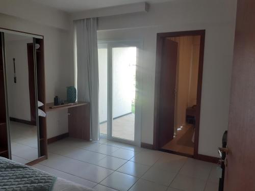 a bedroom with a door leading into a room at Tree Bies Resort - Oficial in Subaúma