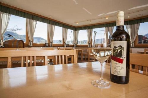 a bottle of wine sitting on a table with a glass at Winzerhof - Gästehaus Stöger in Dürnstein