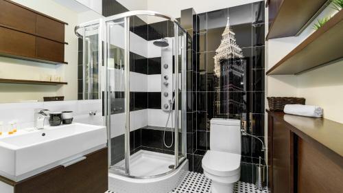 a bathroom with a shower and a toilet and a sink at Sailor Apartments - Neptun Park by OneApartments in Gdańsk