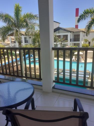 a balcony with a table and a view of the pool at Tree Bies Resort - Oficial in Subaúma