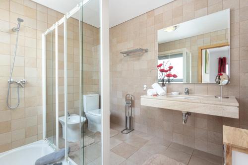 a bathroom with a shower and a toilet and a sink at Privilege Sea View Apartment Arte Nova - Fuzeta in Moncarapacho