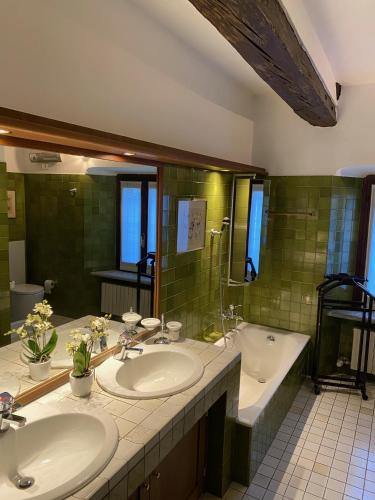 a bathroom with two sinks and a tub at La Ghirba in Santa Maria Maggiore