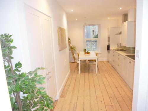 a kitchen with a table and a dining room at Stunning townhouse at Plymouth Hoe in Plymouth