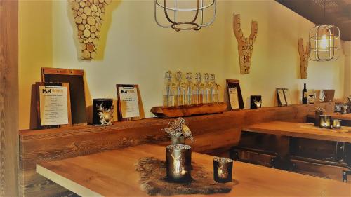 a room with a table and a counter with wine glasses at Haus Veronika - Appartements by Miha in Westendorf