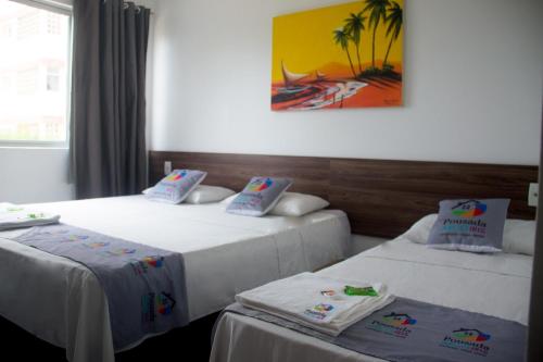 Pousada Arco Iris Fortaleza tesisinde bir odada yatak veya yataklar