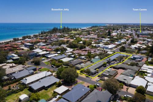 an aerial view of a city with houses and the ocean at Busselton Gale Street Motel & Villas in Busselton
