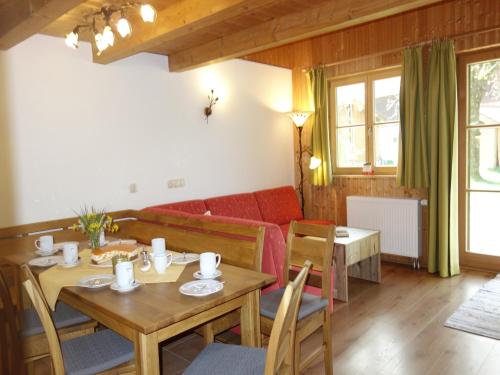 a living room with a table and a couch at Doblerhof in Höslwang
