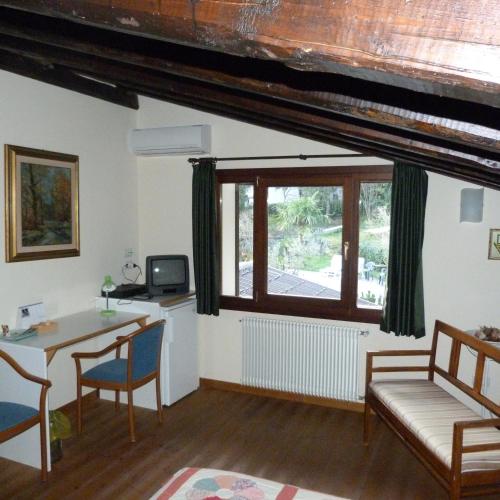 a living room with a table and a window at Villa Margherita in Anduins
