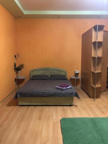 a bedroom with a bed and two night stands at Квартира-студия на Котляра in Kharkiv