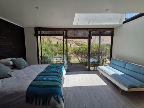 a bedroom with a bed and a window at Reset Elqui in Alcoguaz
