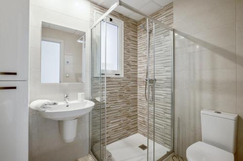 a bathroom with a toilet and a sink and a shower at Spacious Apartment in Orihuela with Sea View in Playas de Orihuela