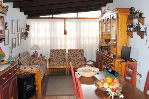 a kitchen and living room with a table and chairs at Cosy House in La Sabinita with Mountain View in La Sabinita
