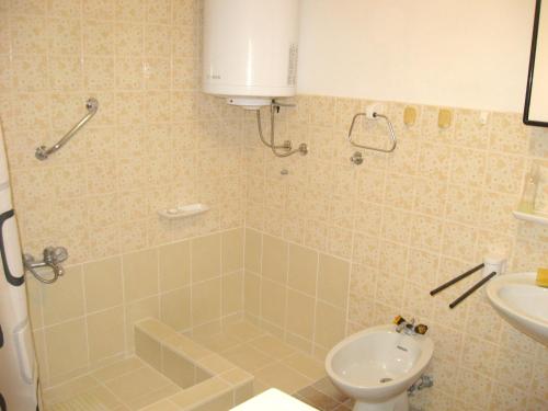 a bathroom with a shower and a toilet and a sink at 3 bedrooms house at Sveti Jakov 400 m away from the beach with enclosed garden and wifi in Sveti Jakov