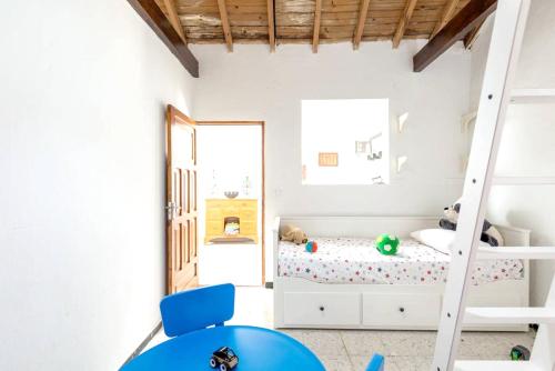 a childs bedroom with a bunk bed and a ladder at Charming House in Temisas with Parking and Air Conditioning in Temisas
