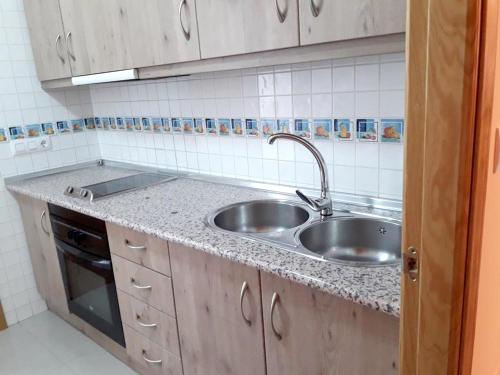 a kitchen counter with a sink and a stove at Welcoming house with mountain view in Cazorla in Cazorla