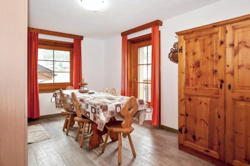 a dining room with a table and chairs at Comfortable Apartment in Livigno with Balcony in Livigno