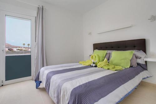 a bedroom with a bed with a stuffed animal on it at One bedroom apartement at Tias 500 m away from the beach with shared pool furnished terrace and wifi in Tías