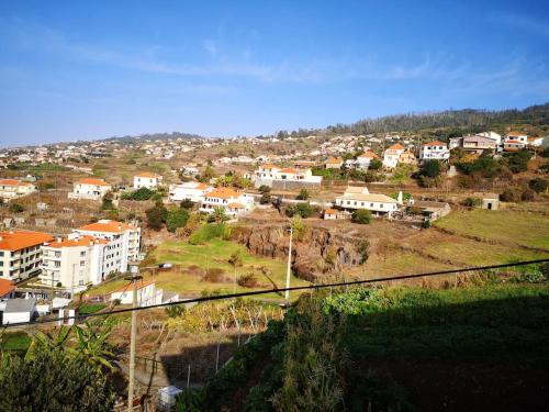 a view of a city with buildings on a hill at Elegant House in Calheta, Sea View in Calheta